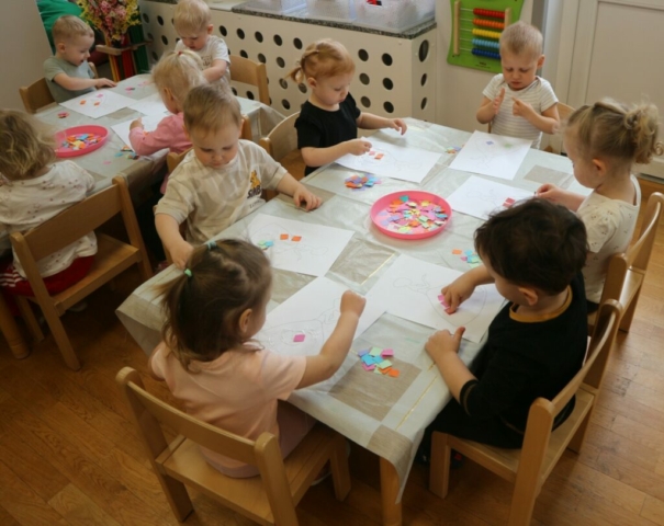 Wyklejanie kolorowym papierem sylwety Pani Wiosny